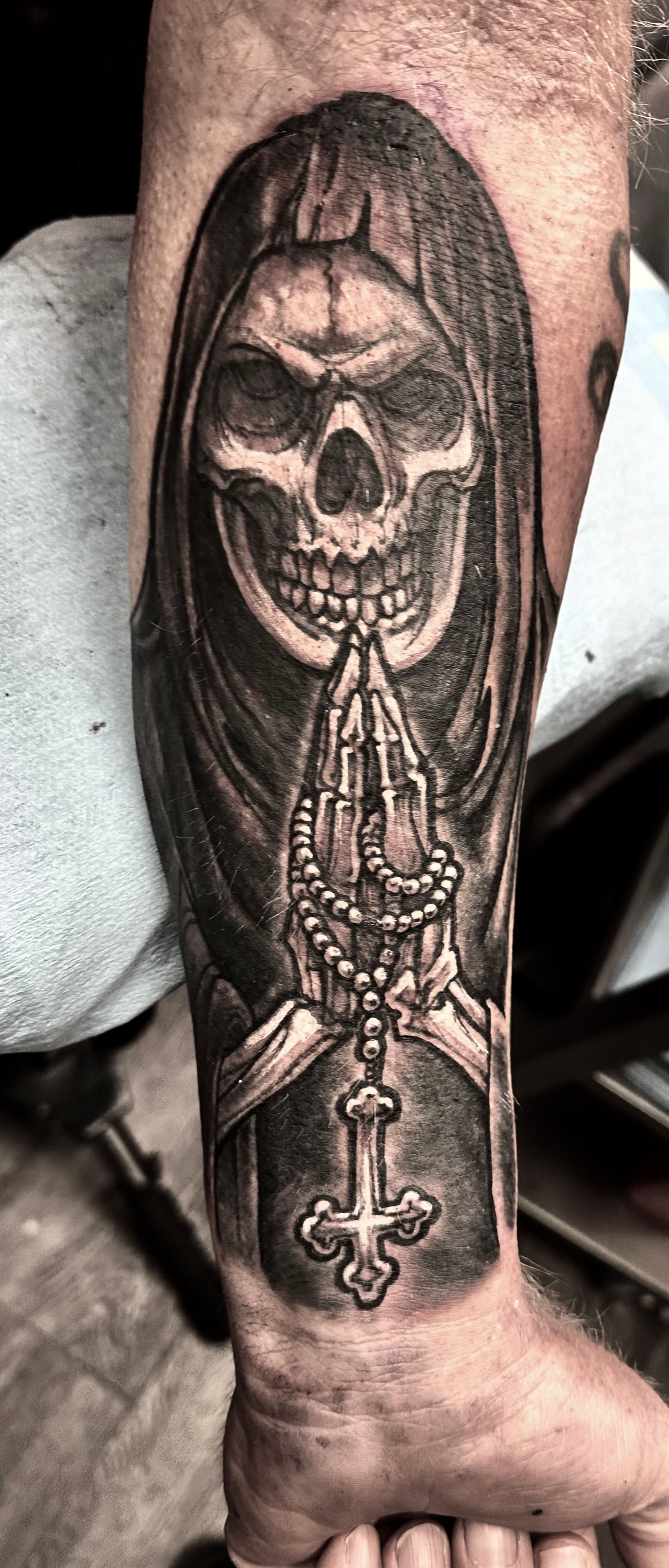 Skeleton with praying hands tattoo
