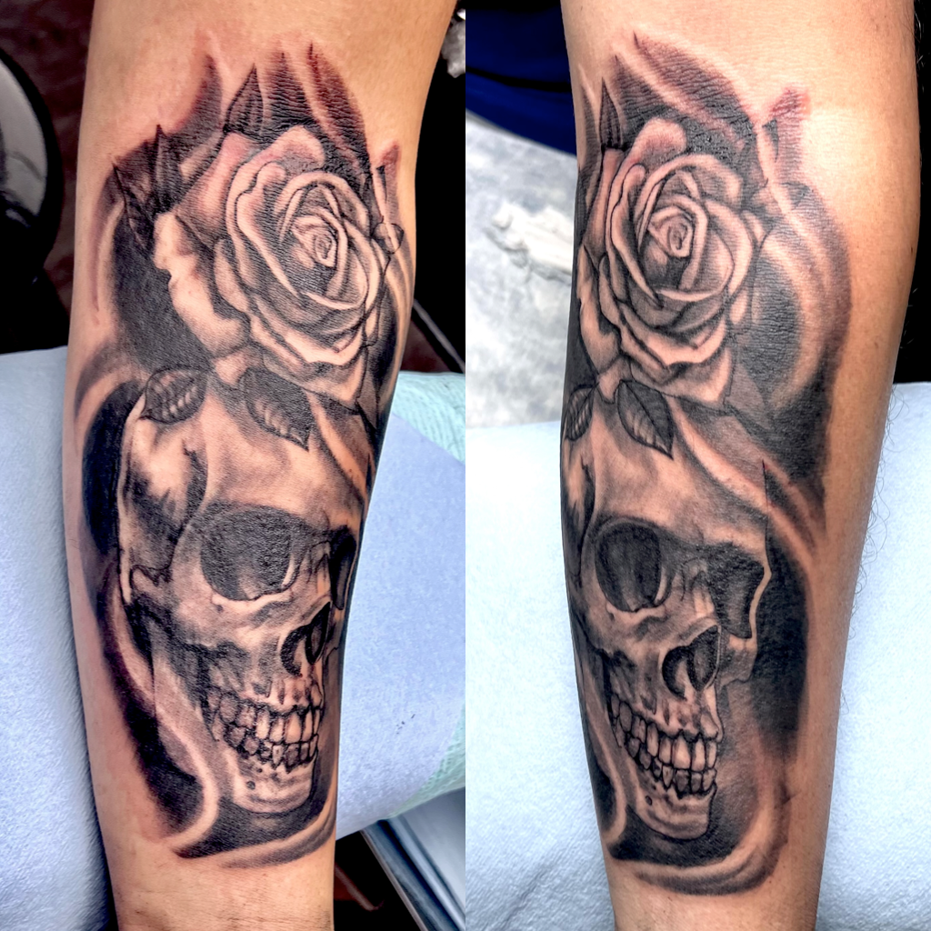 Skull and roses tattoo in black and gray
