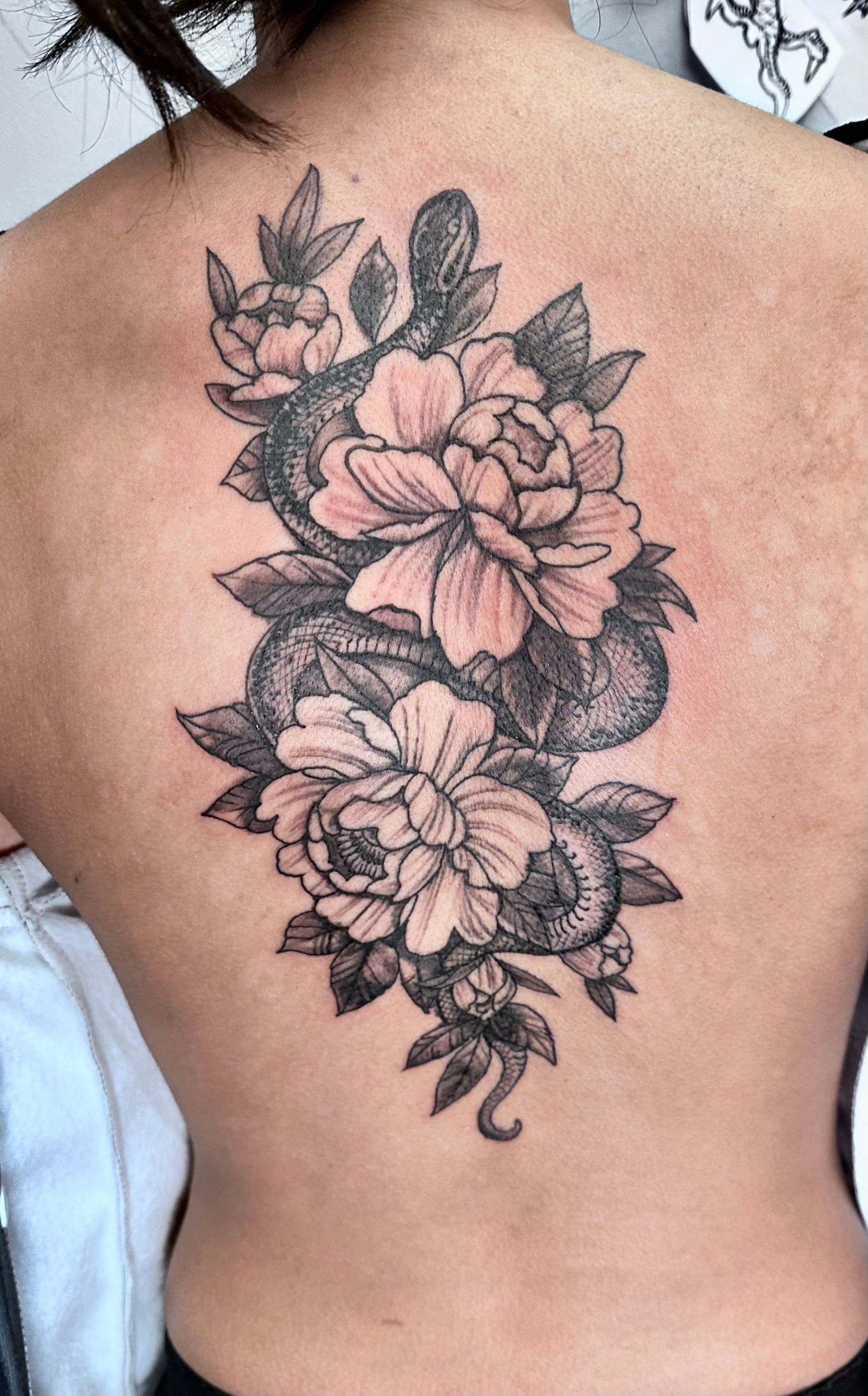 Snake and flowers tattoo