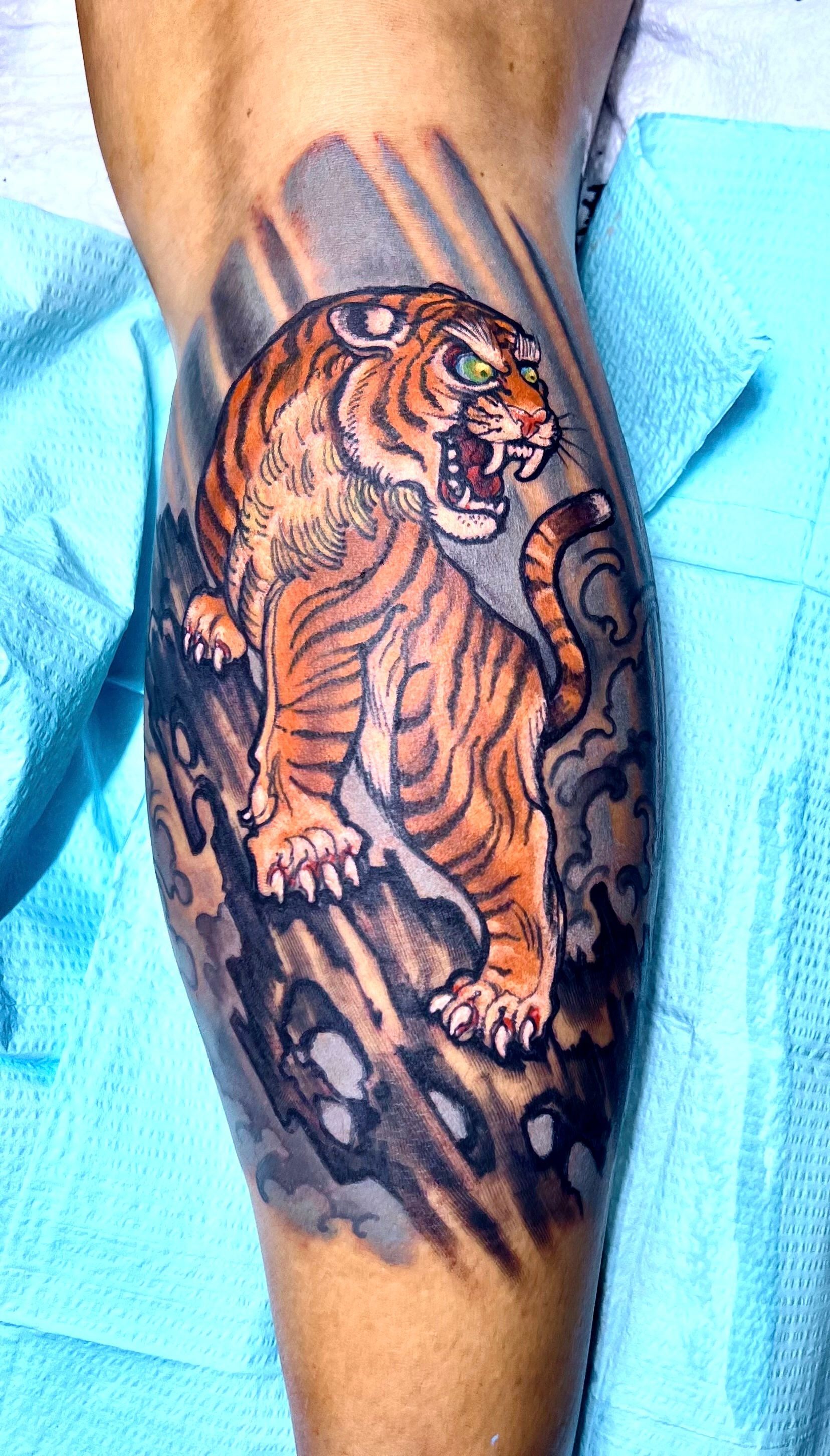 Tiger on rock tattoo