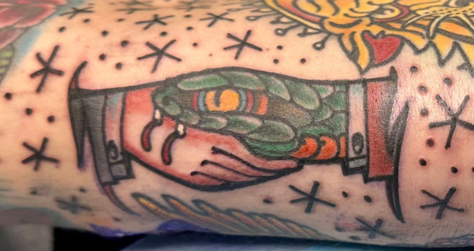 Hand Shake with a Snake Tattoo