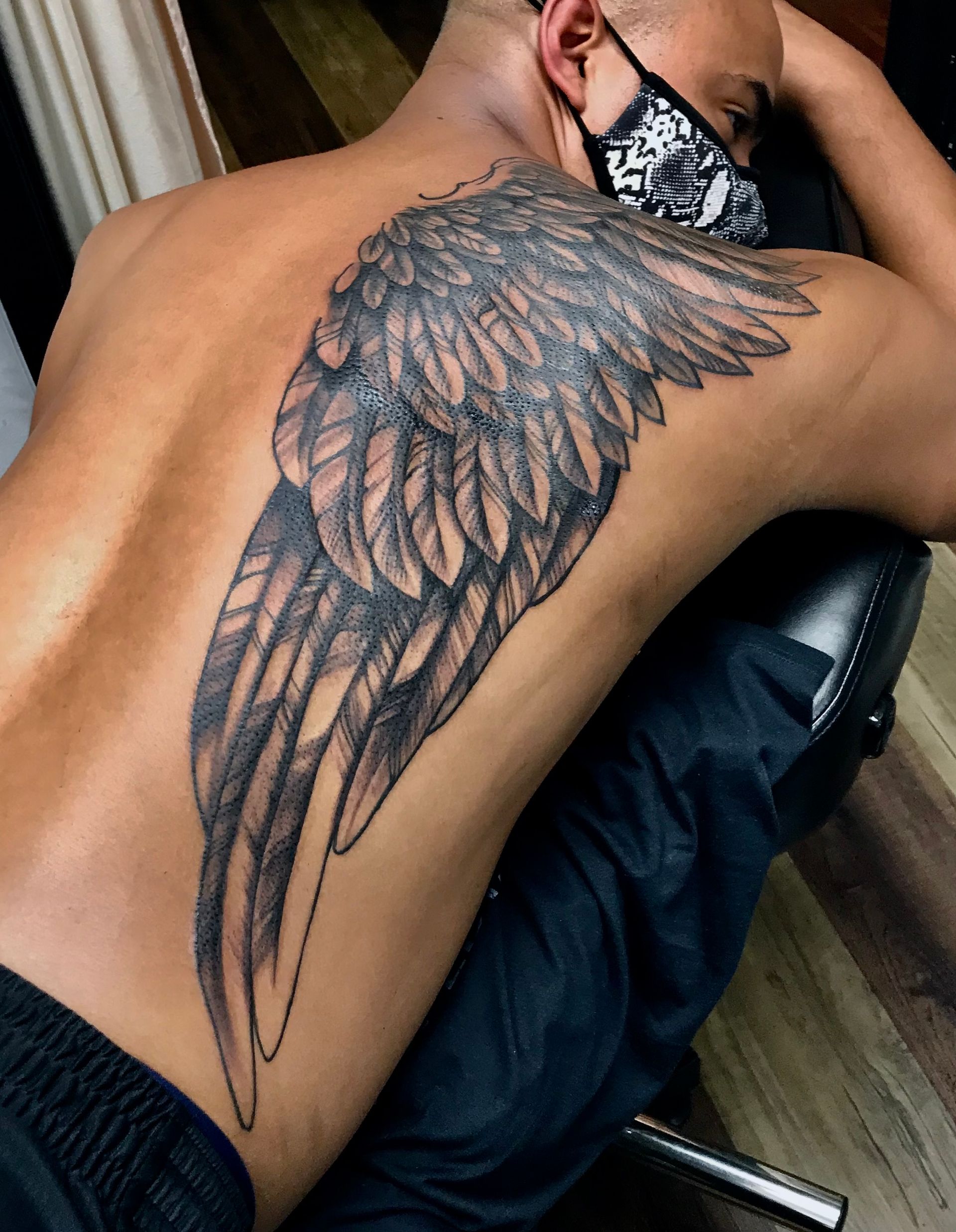 Wing tattoo on back