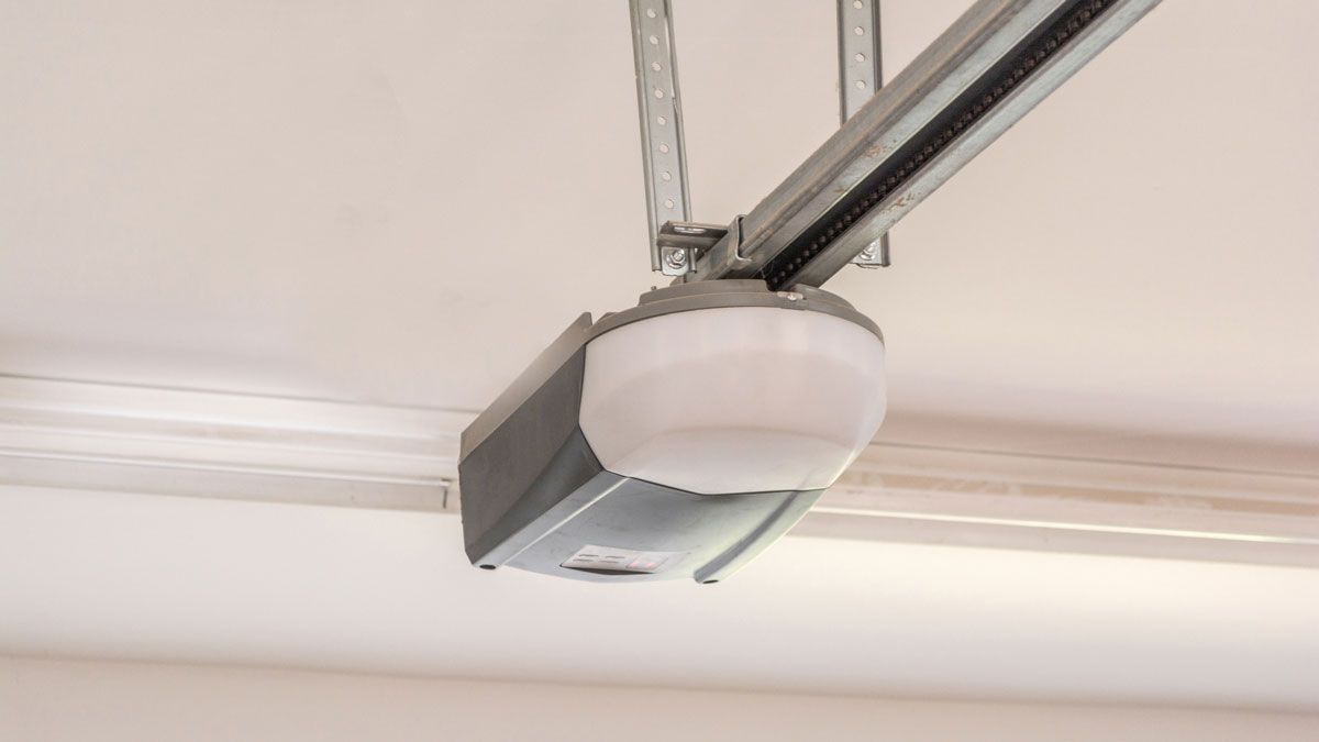 Garage door opener mounted on a white ceiling.