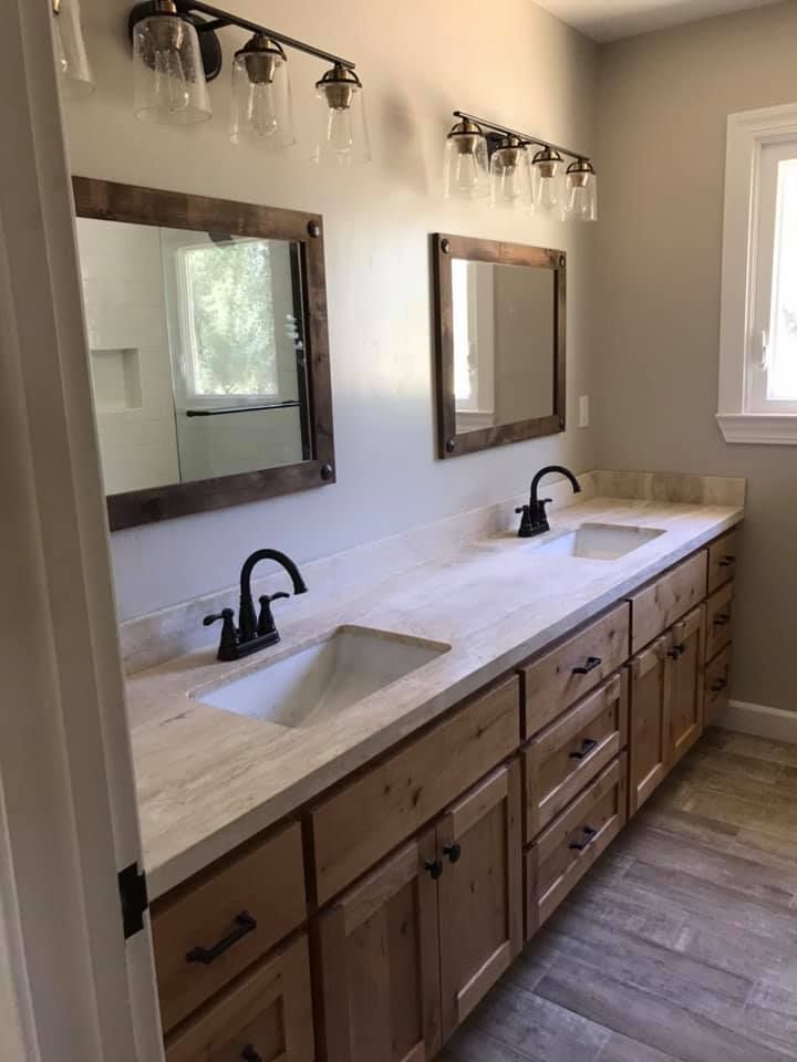 A bathroom with two sinks and two mirrors.
