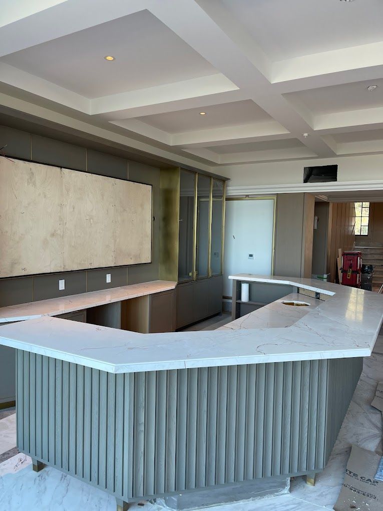 A large room with a long counter in the middle of it.