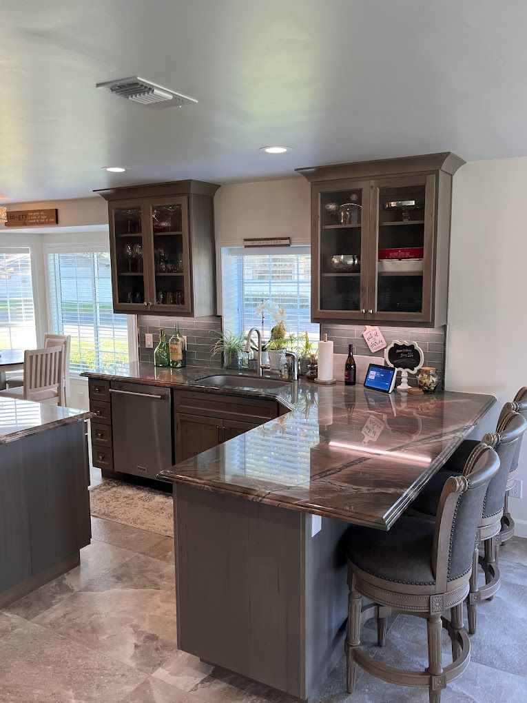 A kitchen with a granite counter top and stainless steel appliances.