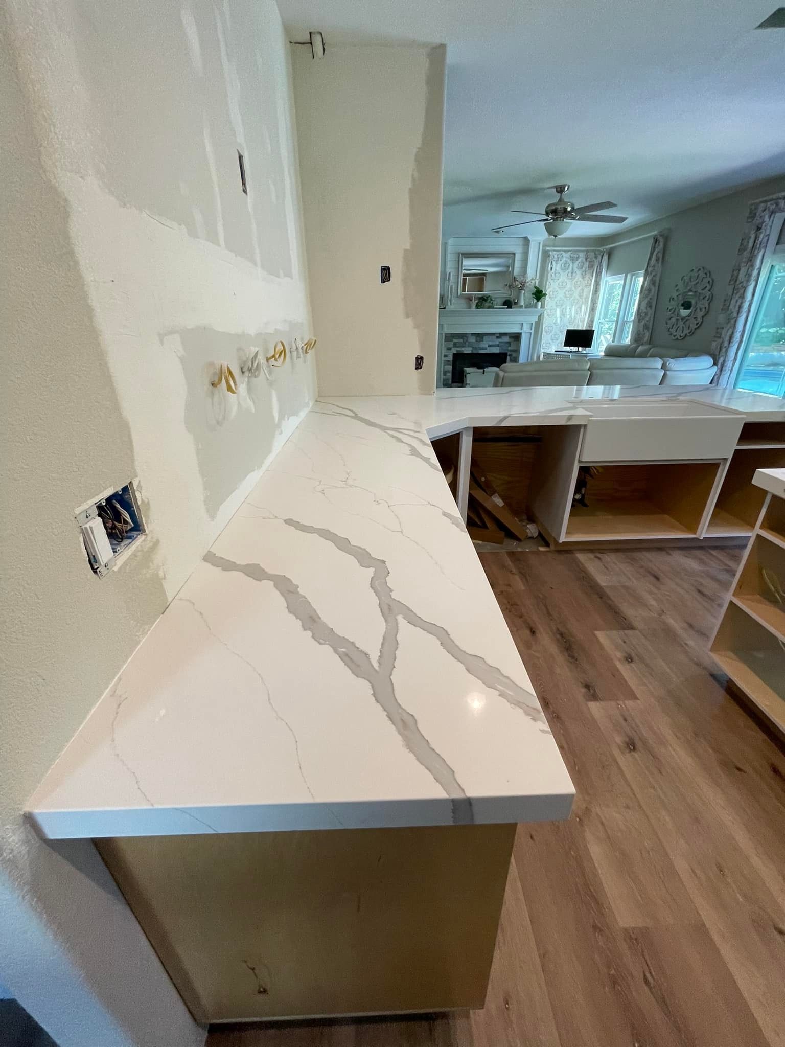White quartz countertop with gray veining installed in a kitchen renovation.