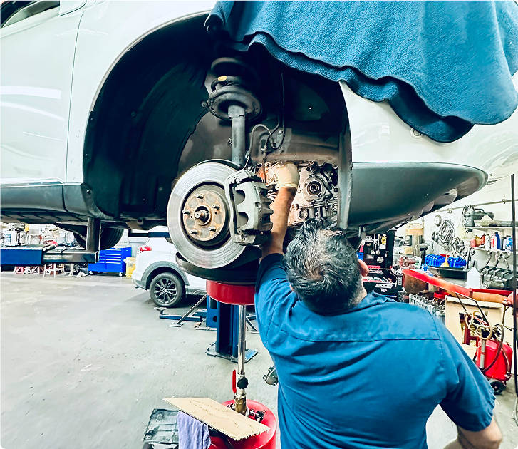 mechanic working on suspension | Craig Johnson Automotive
