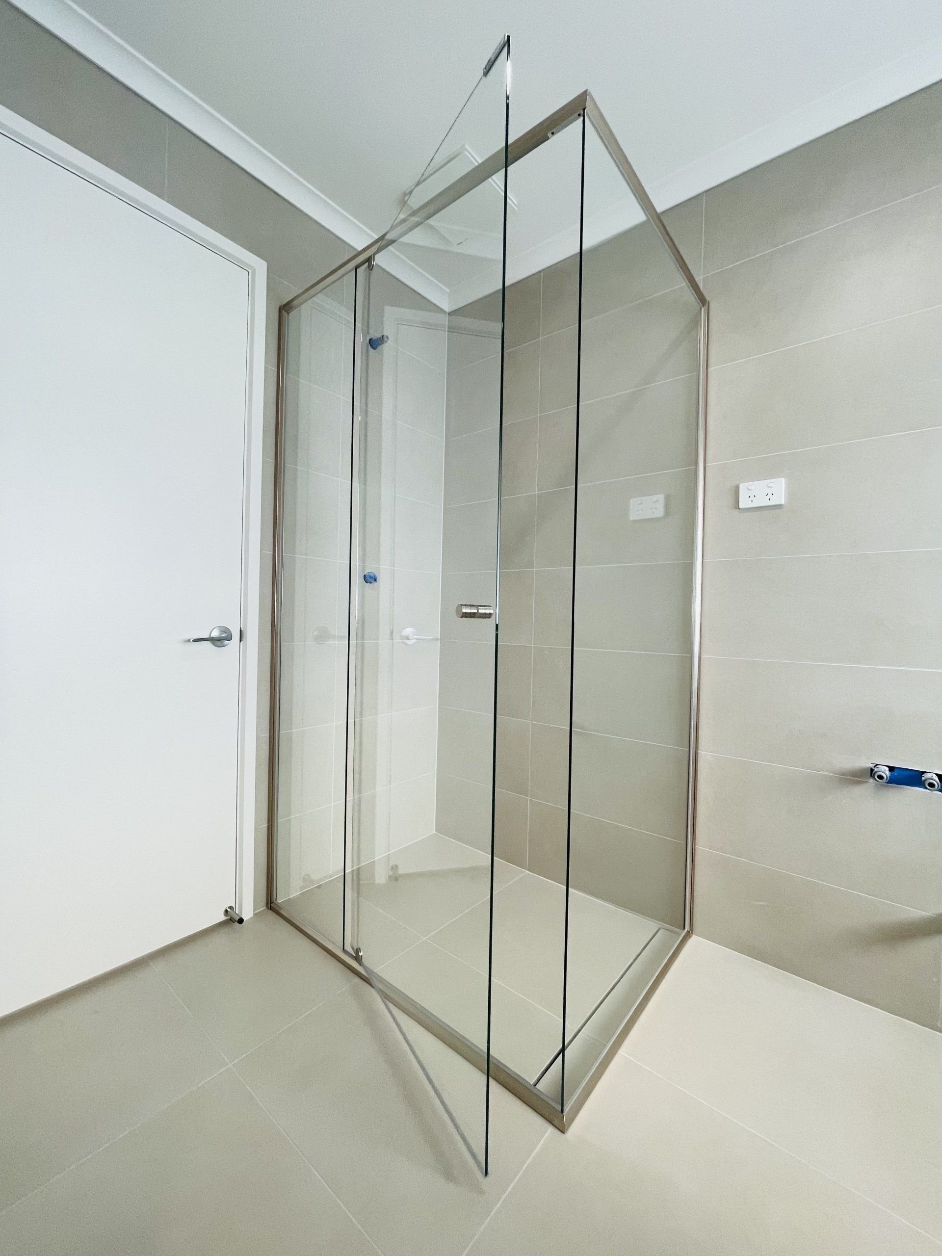 A bathroom with a Evolution Sem-Frameless glass shower door
