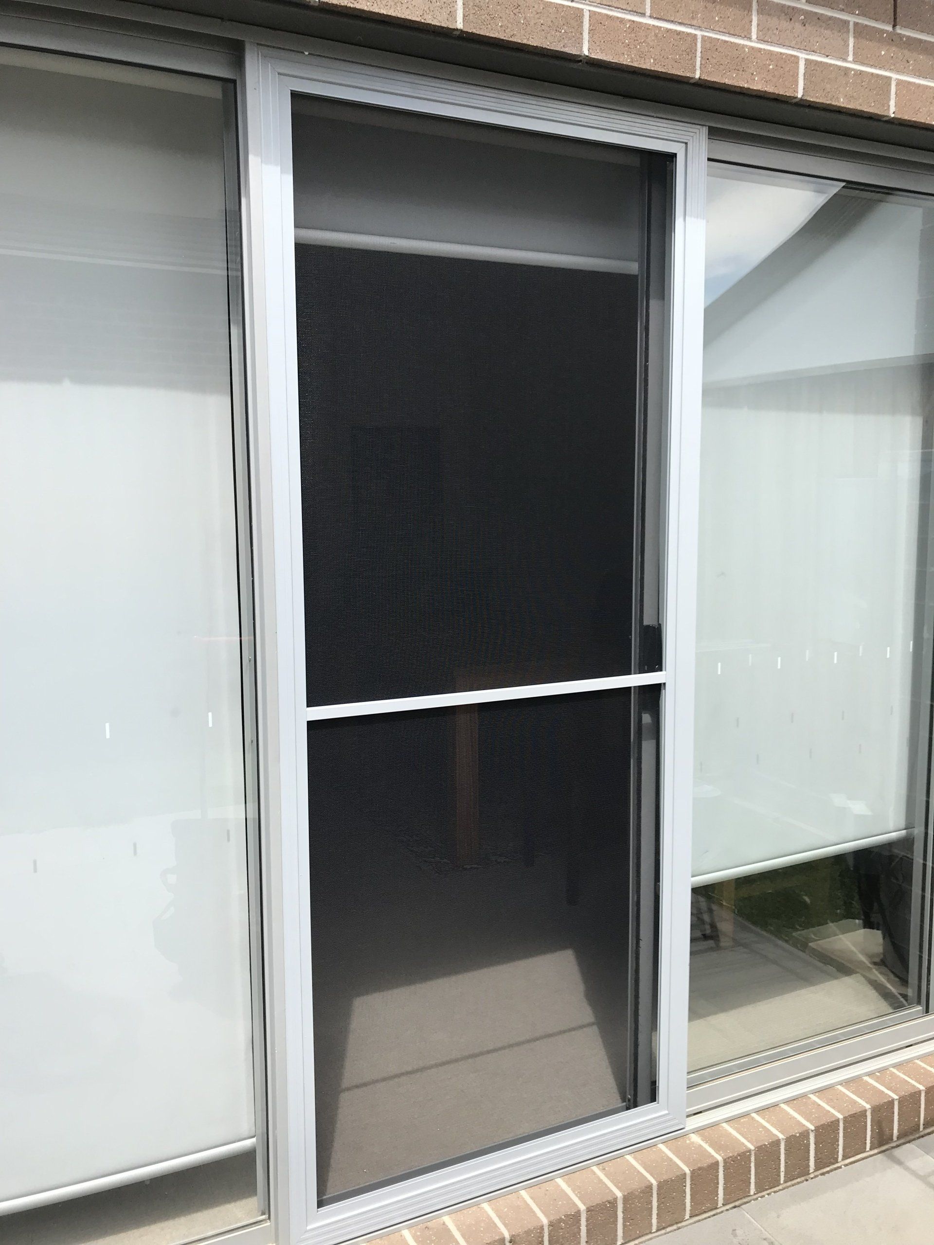 A sliding glass door with a screen on it.