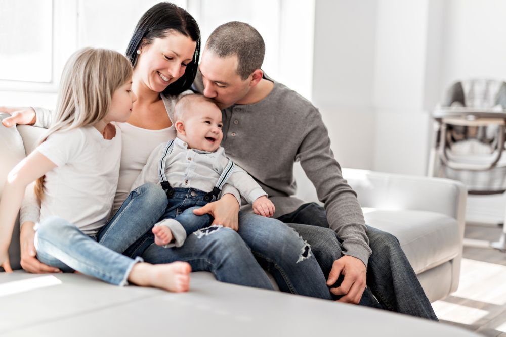 Family of Four Sitting on a Couch — Amanda Jade Photography In Gordonvale, QLD