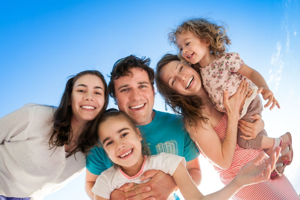 Family of Five Smiling, Looking Up at Camera Against a Blue Sky — Amanda Jade Photography In Gordonvale, QLD