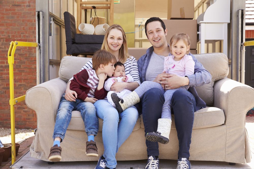 Family of Five Sitting on a Couch in a Moving Truck — Amanda Jade Photography In Gordonvale, QLD