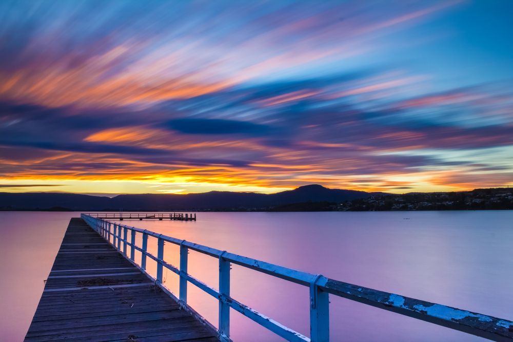 Pier Stretching Into Calm Water at Sunset — Amanda Jade Photography In Gordonvale, QLD