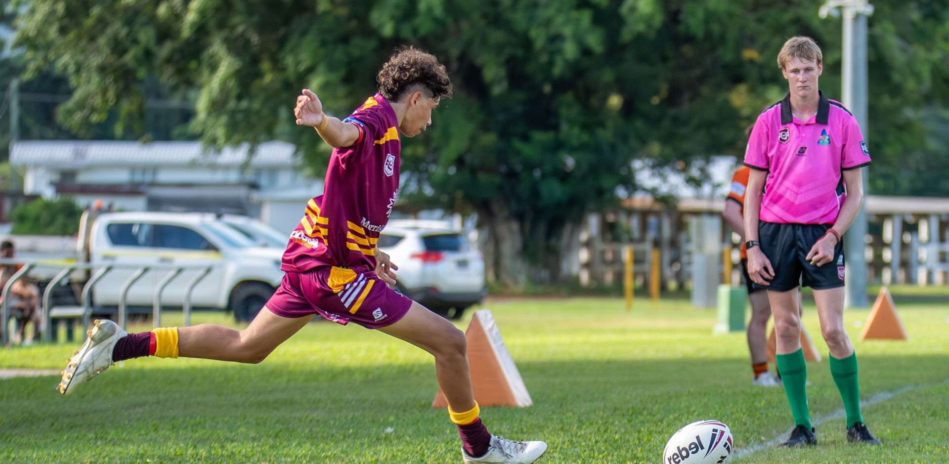 a Rugby Player Kicking the Ball on a Green Field — Amanda Jade Photography In Gordonvale, QLD
