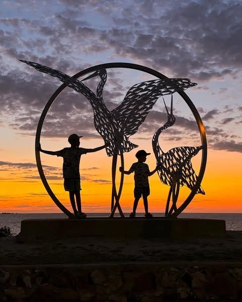 Silhouette Of Two Children With A Metal Sculpture Of Cranes In A Circle — Amanda Jade Photography In Atherton Tablelands, QLD