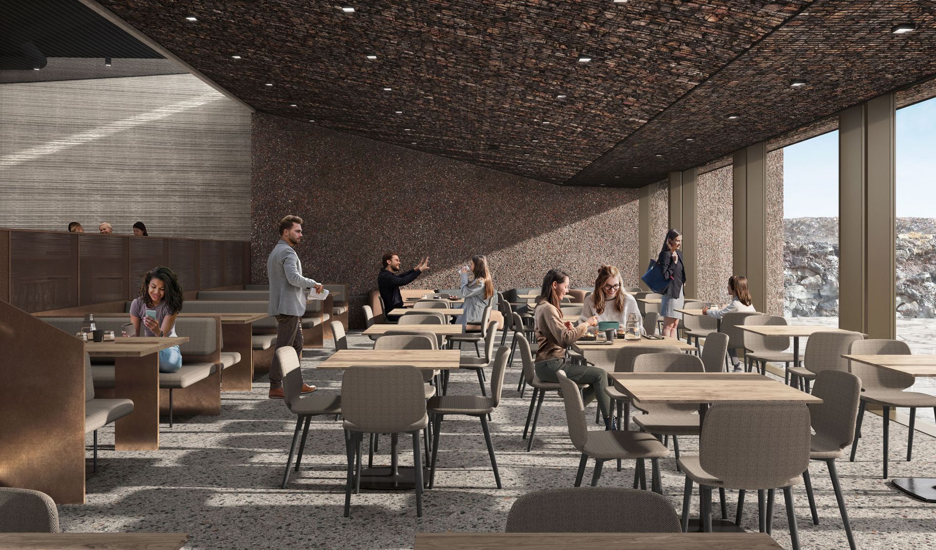 Interior of a modern cafe with patrons, a long table, and a textured wall.