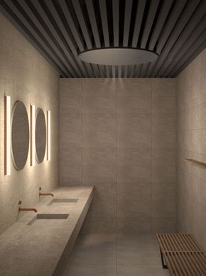 Neutral-toned bathroom with sinks, mirrors, and bench. Modern design with dim lighting.