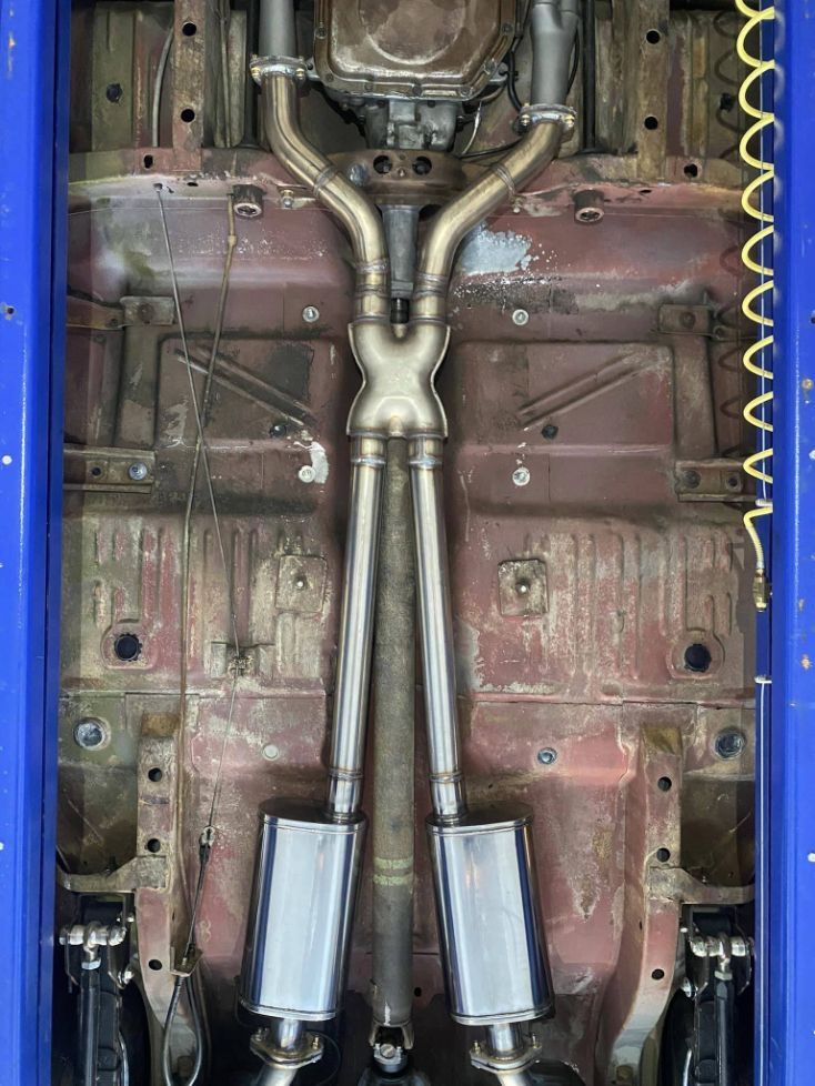 A Close Up of the Underside of a Car With Exhaust Pipes  — Savins Radiator Service In Lismore, NSW