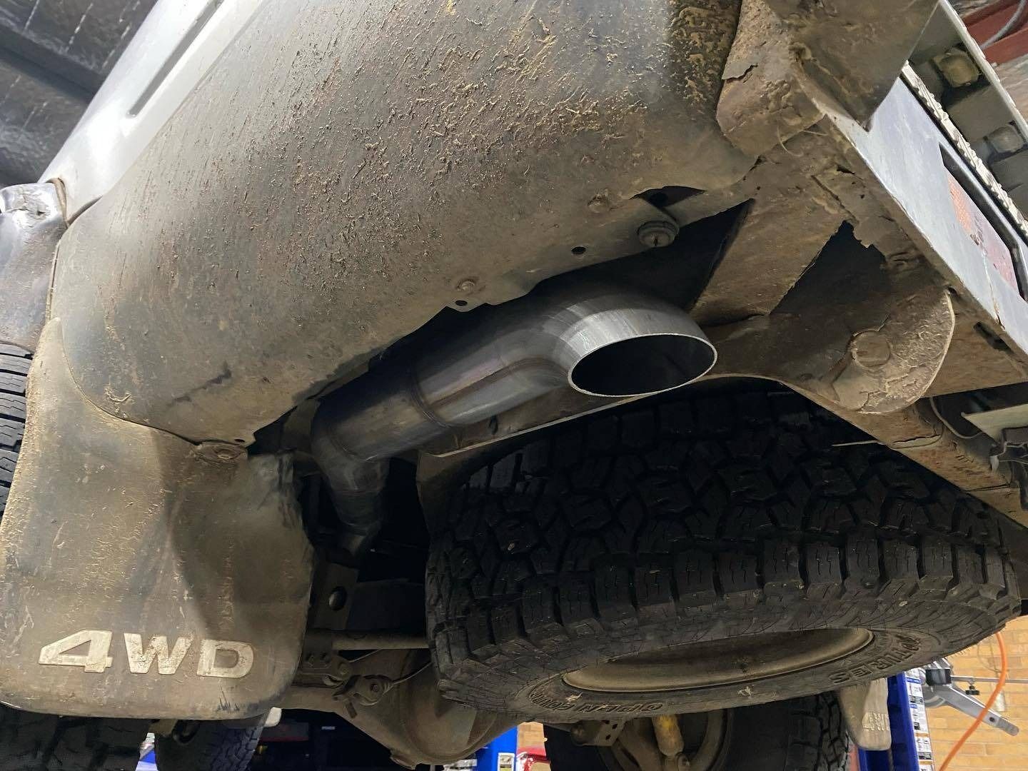 The Exhaust Pipe of a 4wd Truck is Visible Underneath the Vehicle — Savins Radiator Service In Lismore, NSW