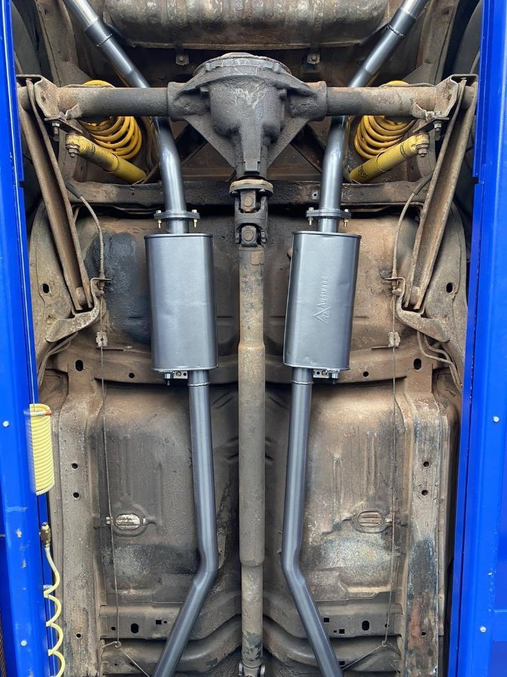 The Underside of a Car With Exhaust Pipes Attached to It — Savins Radiator Service In Lismore, NSW