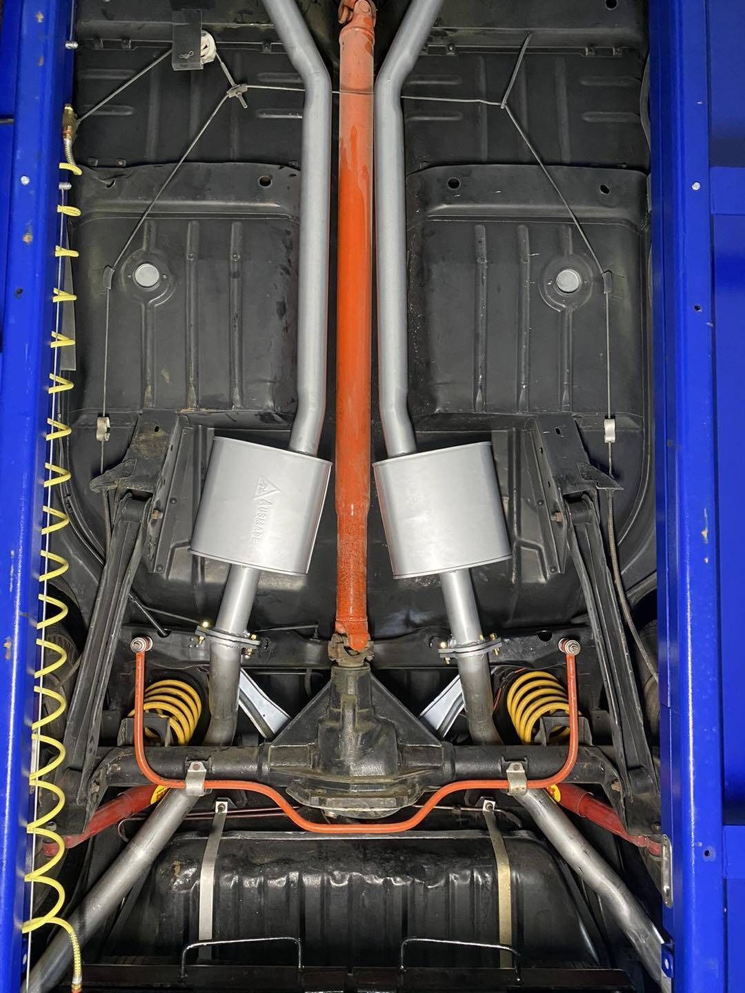 The Underside of a Blue Car With Exhaust Pipes — Savins Radiator Service In Lismore, NSW