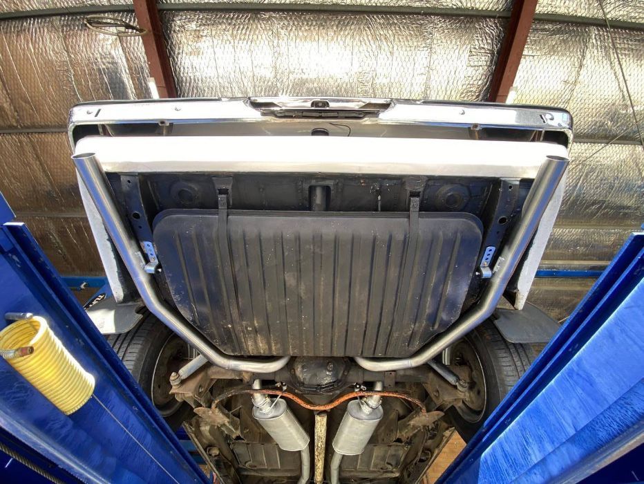 A Car is Sitting on a Lift in a Garage — Savins Radiator Service In Lismore, NSW