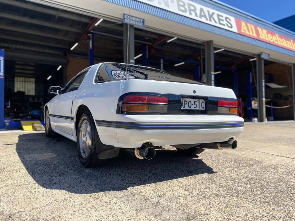 A White Car is Parked in Front of a Garage — Savins Radiator Service In Lismore, NSW