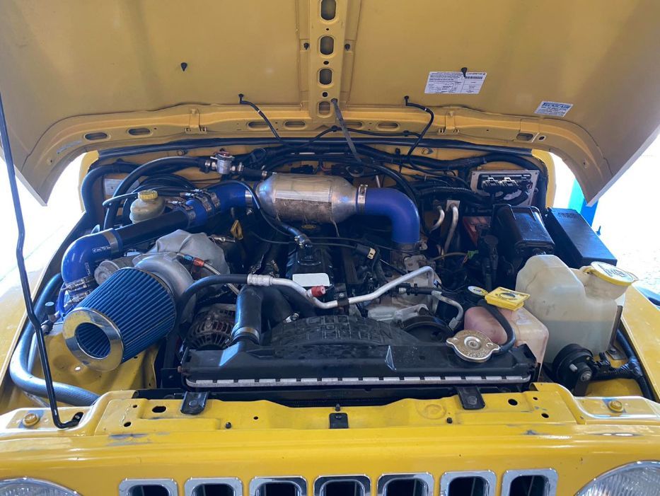 The Engine of a Yellow Jeep is Shown With the Hood Open — Savins Radiator Service In Lismore, NSW