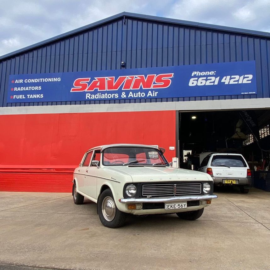 A White Car is Parked in Front of a Building — Savins Radiator Service In Lismore, NSW