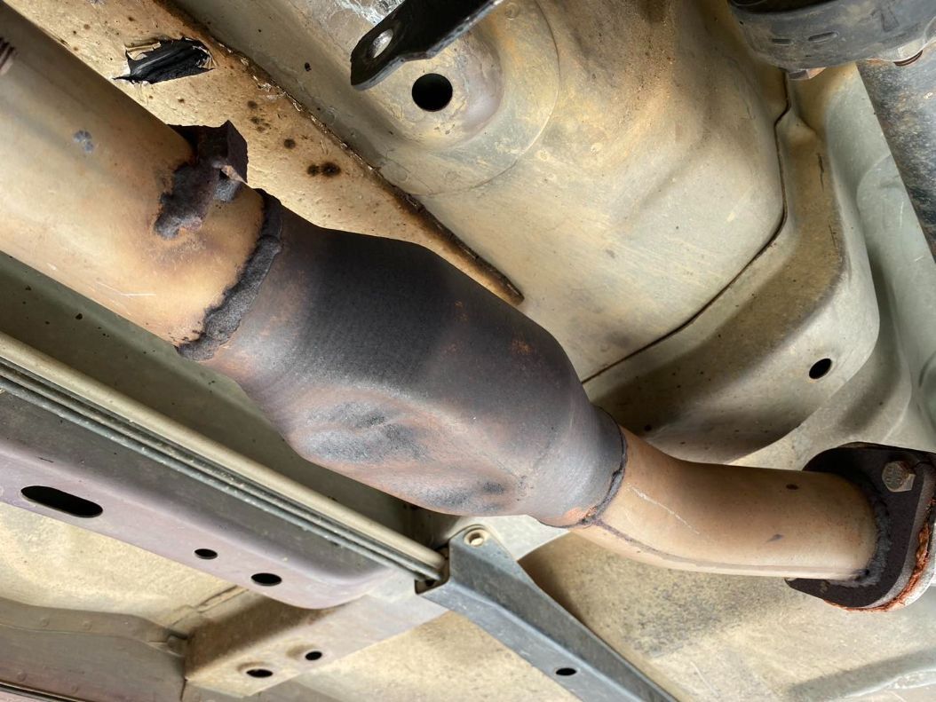 A Close Up of a Exhaust Pipe Under a Car — Savins Radiator Service In Lismore, NSW