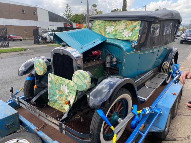 An Old Car is Being Towed on a Trailer — Savins Radiator Service In Lismore, NSW