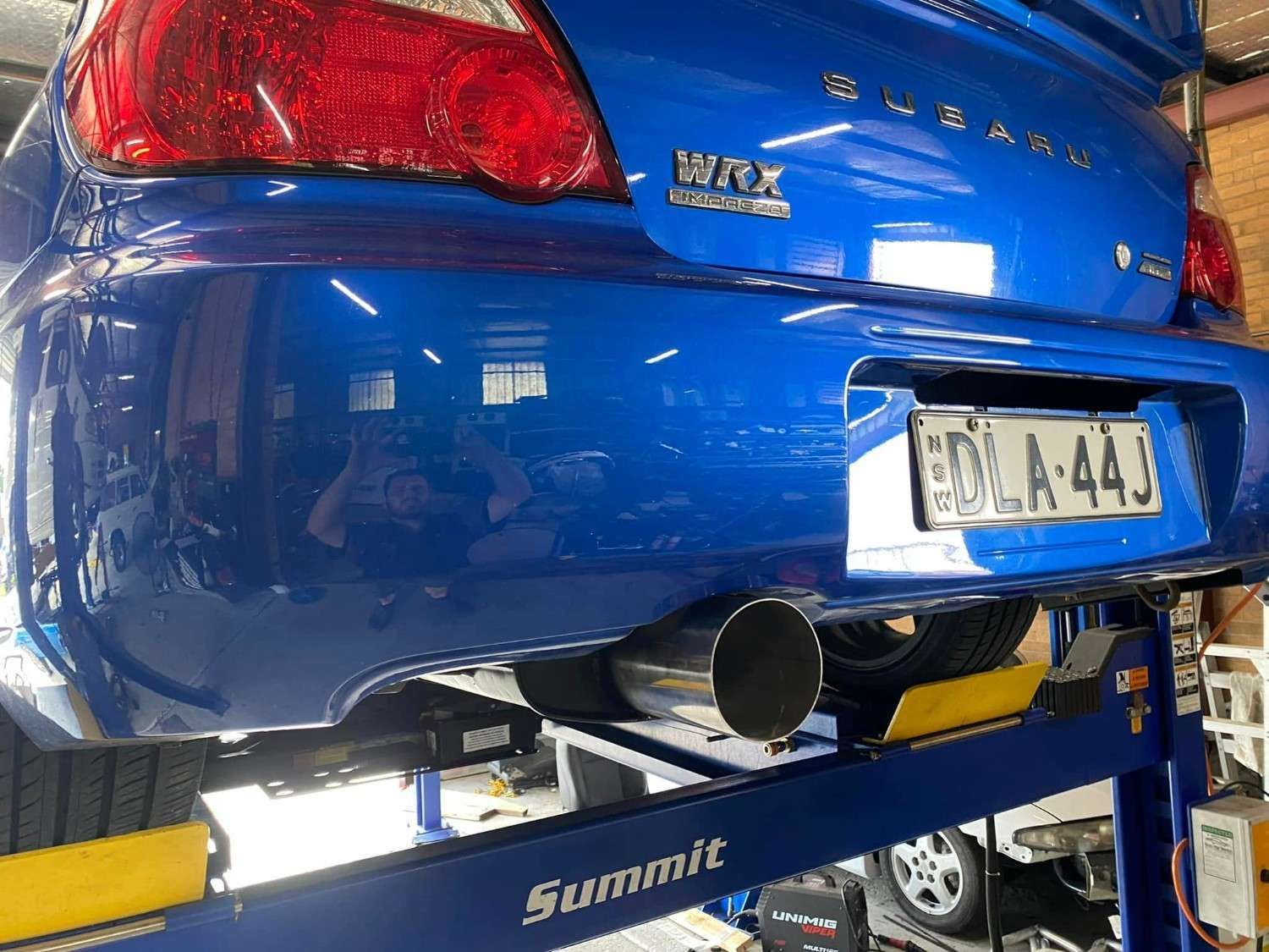 Blue Subaru Wrx Car on A Lift — Savins Radiator Service In Lismore, NSW