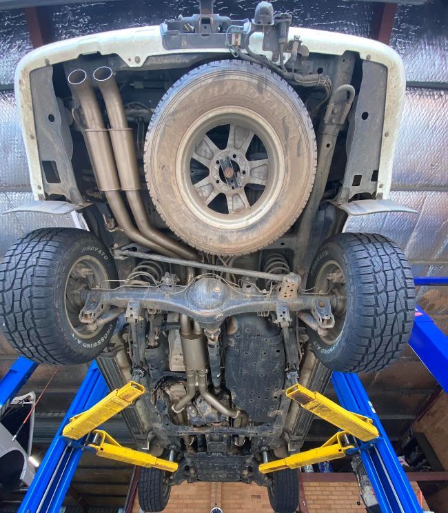 The Underside of a Truck is Shown on a Lift — Savins Radiator Service In Lismore, NSW