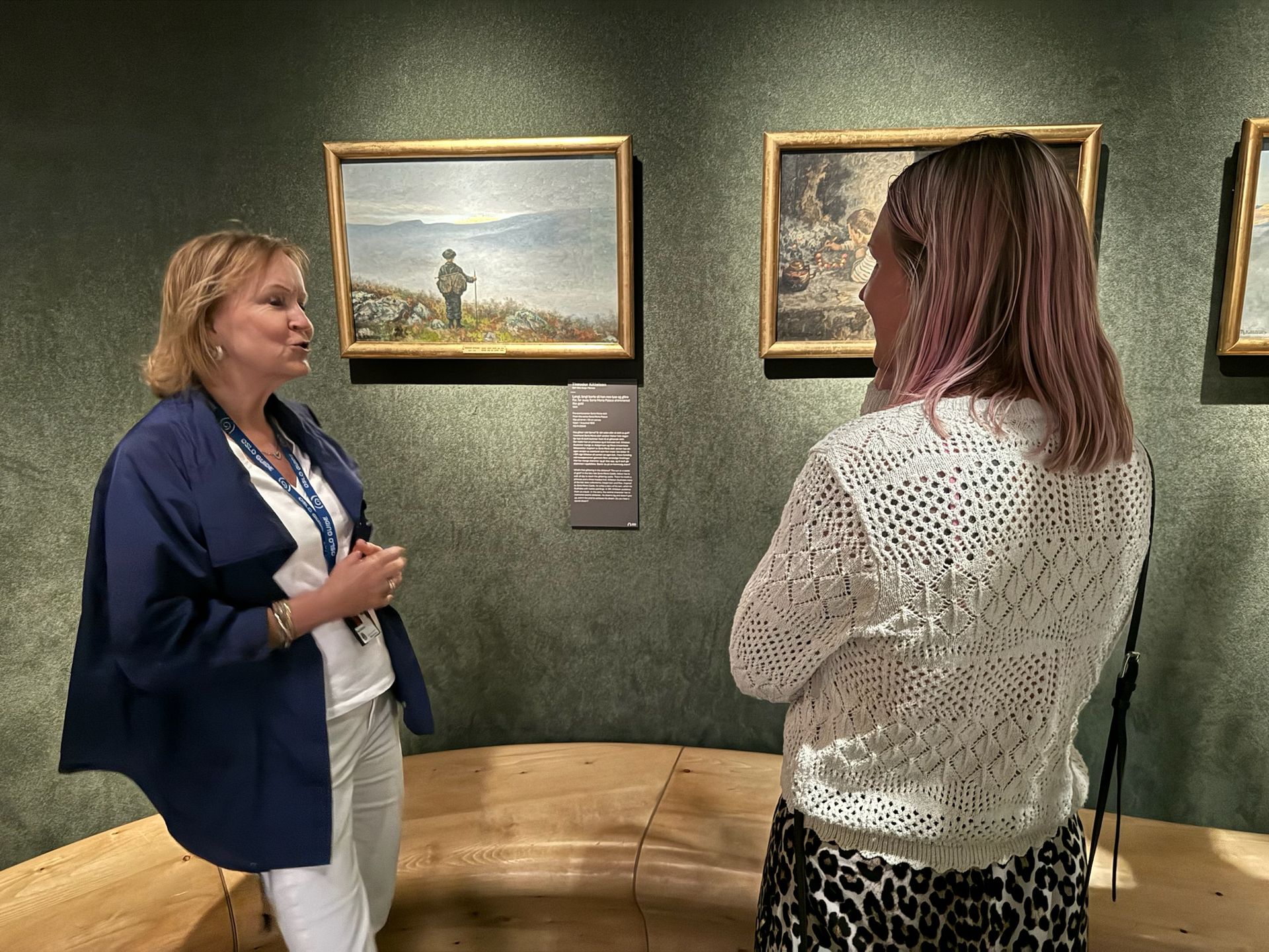 A guide showing paintings at the National Museum 