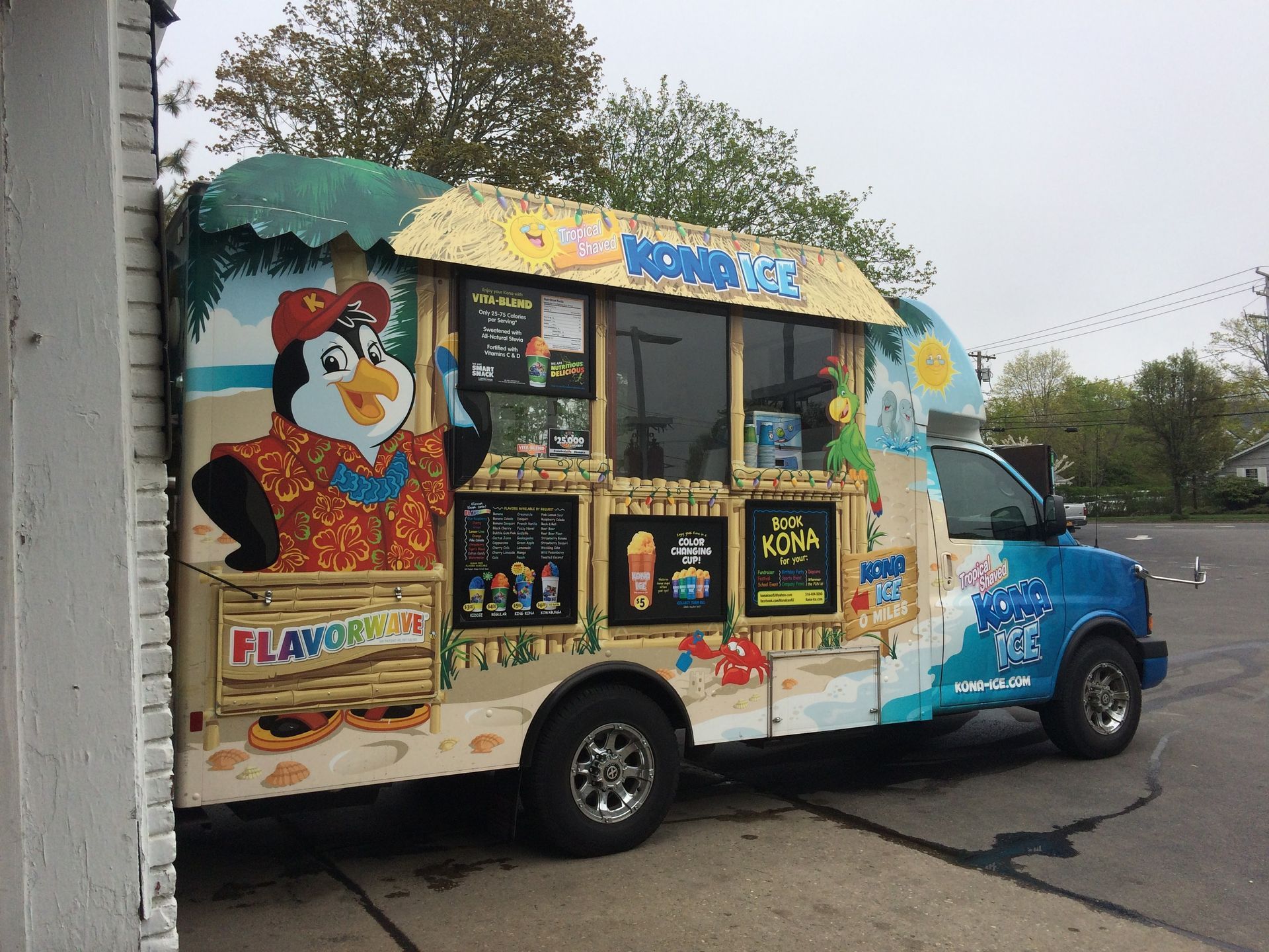 A colorful Kona Ice truck decorated with tropical-themed graphics | C & C Automotive Repair Of The Hamptons, Inc.
