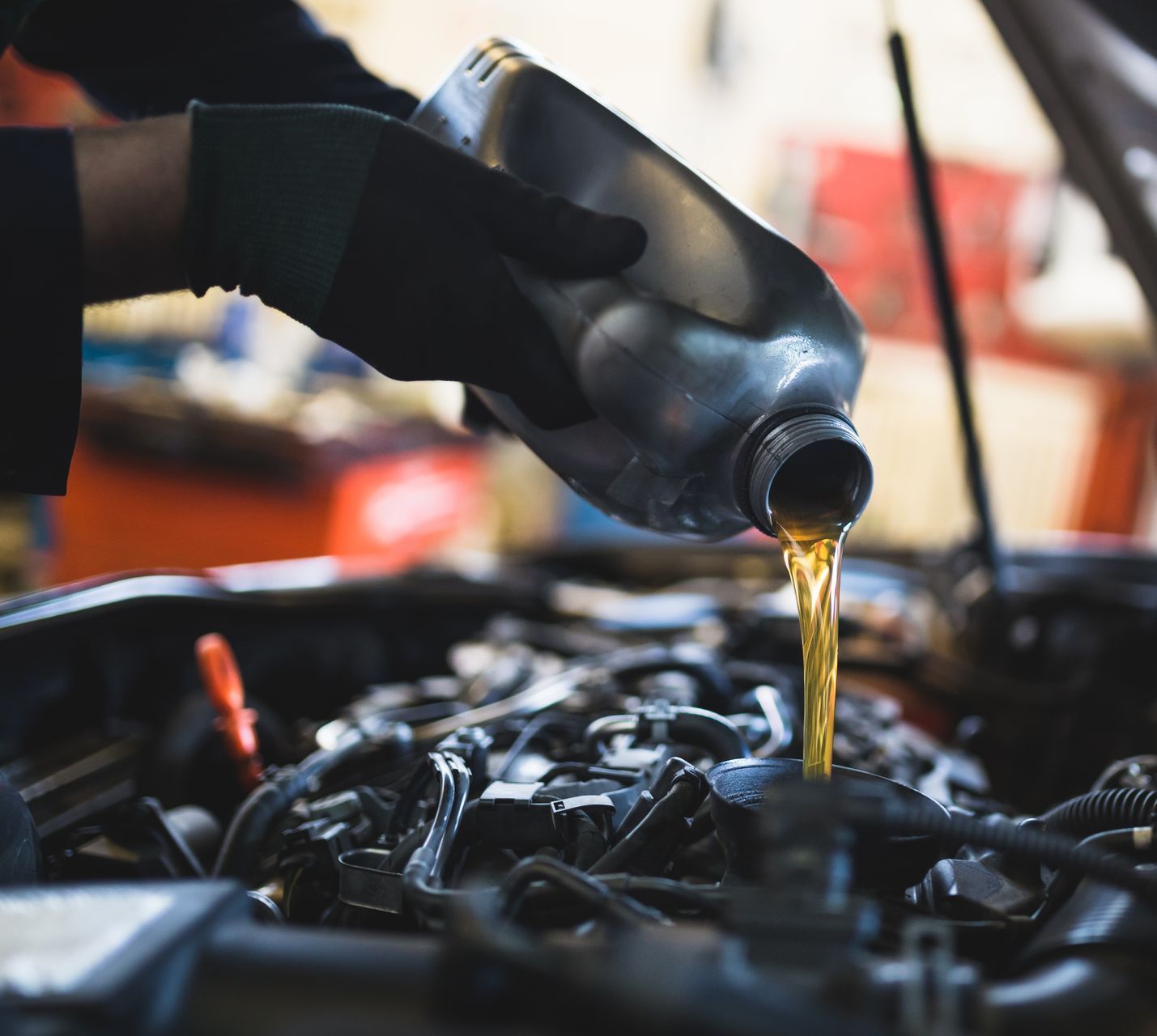Mechanic pouring motor oil into a car engine | C & C Automotive Repair Of The Hamptons, Inc.