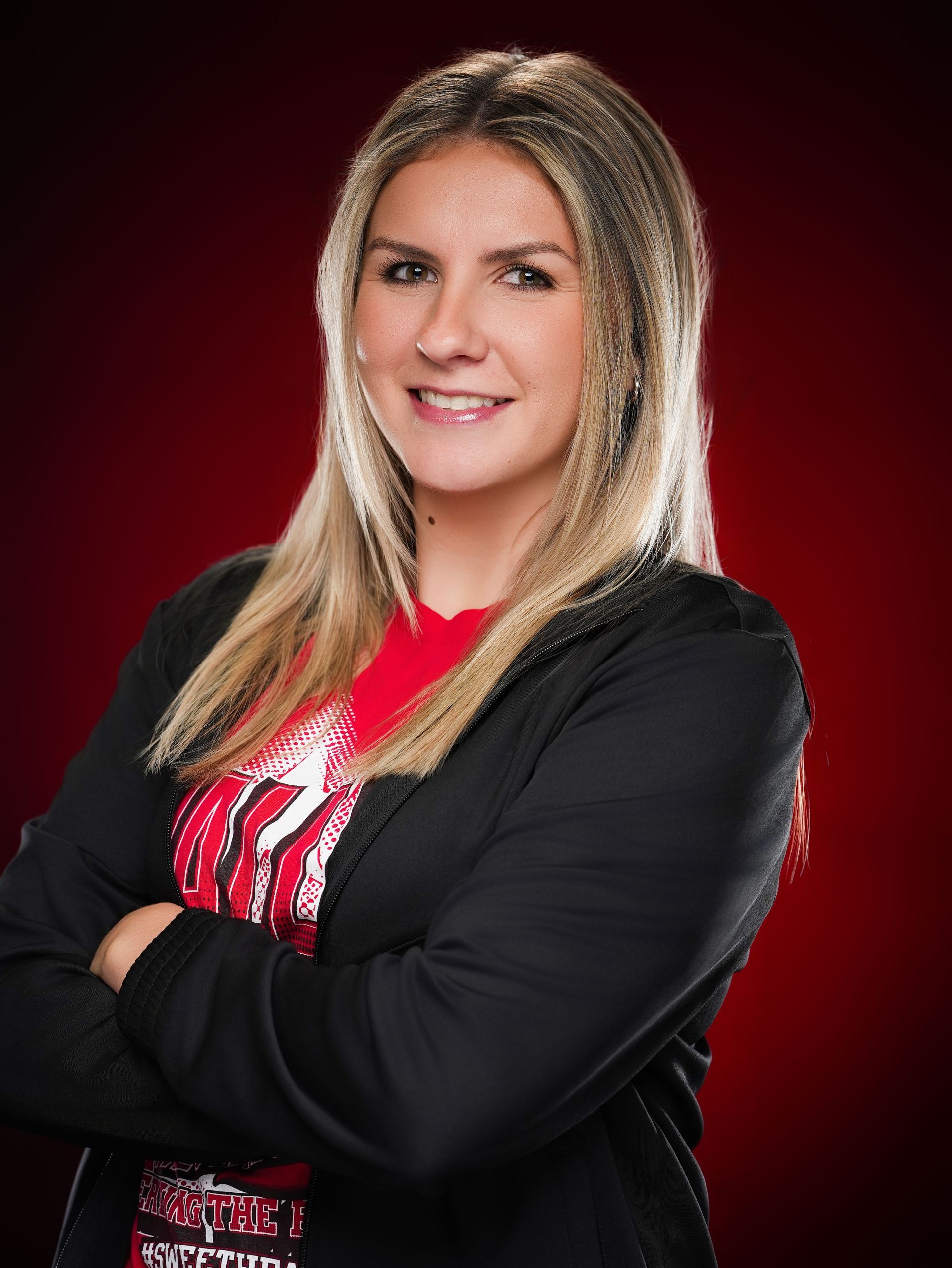 A smiling individual with long blonde hair, 