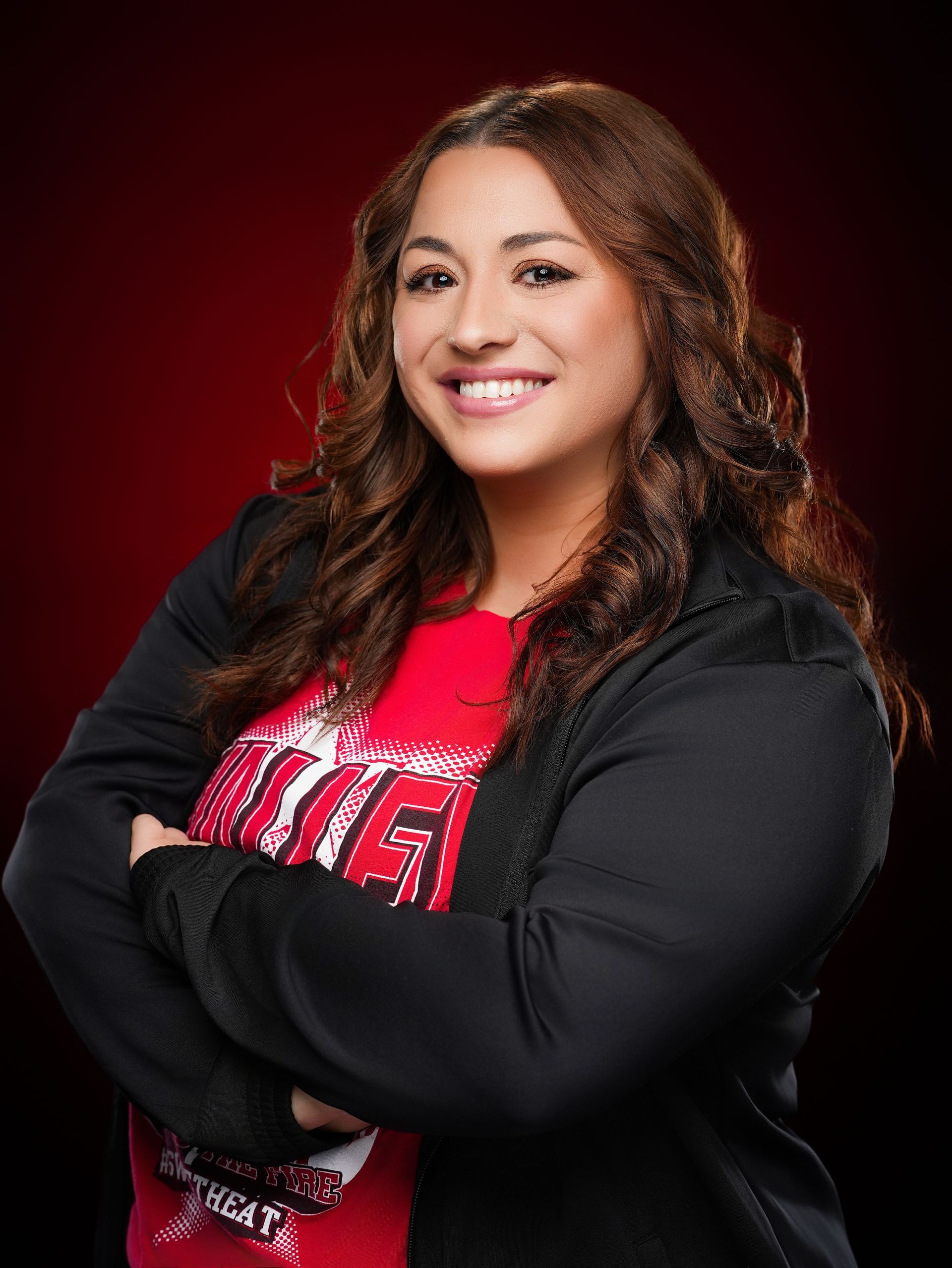 A smiling person with long brown hair, 