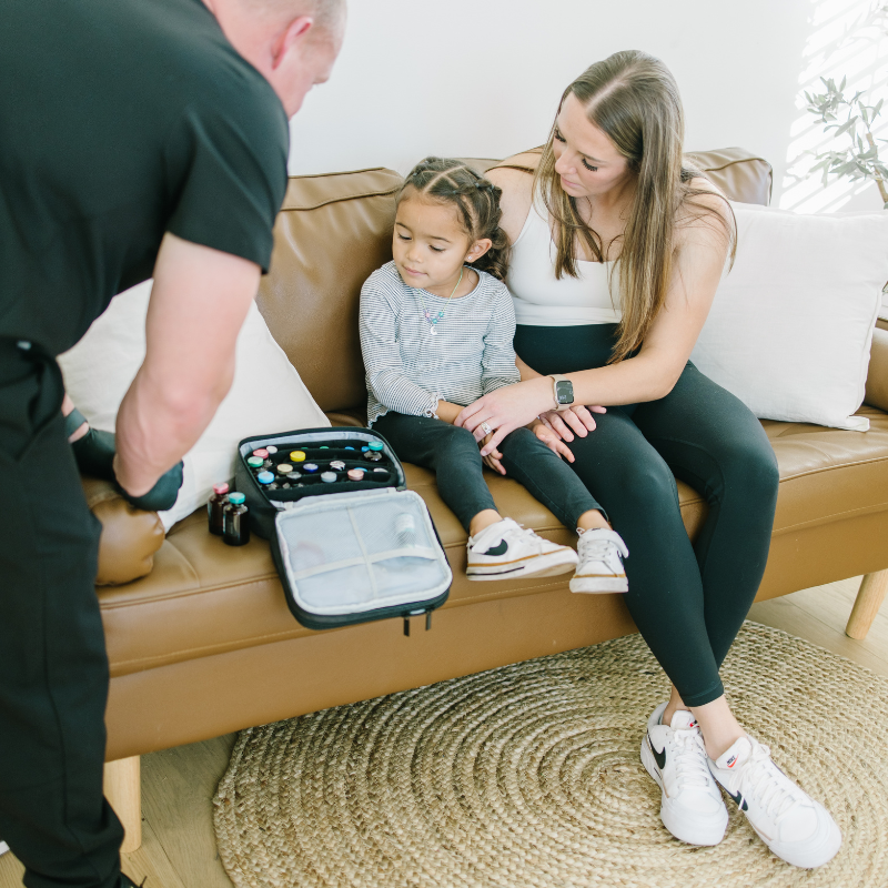A woman and a little girl are sitting on a couch