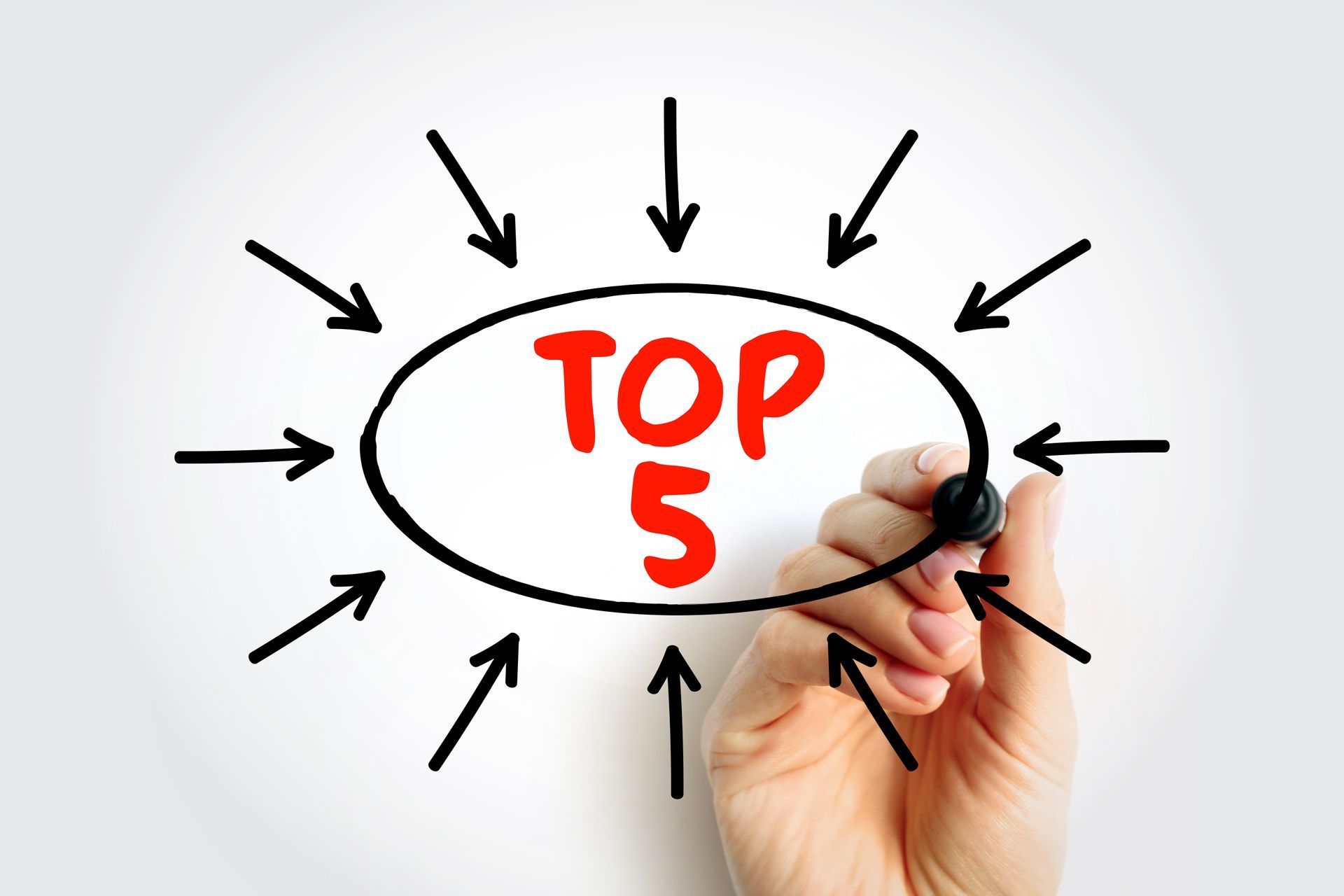A hand is writing the word top 5 on a white board