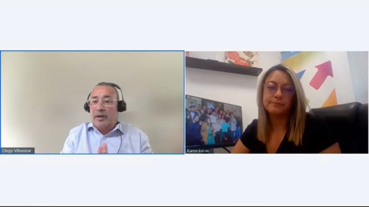 Two people in a video call; man in headset, woman in glasses, both seated.