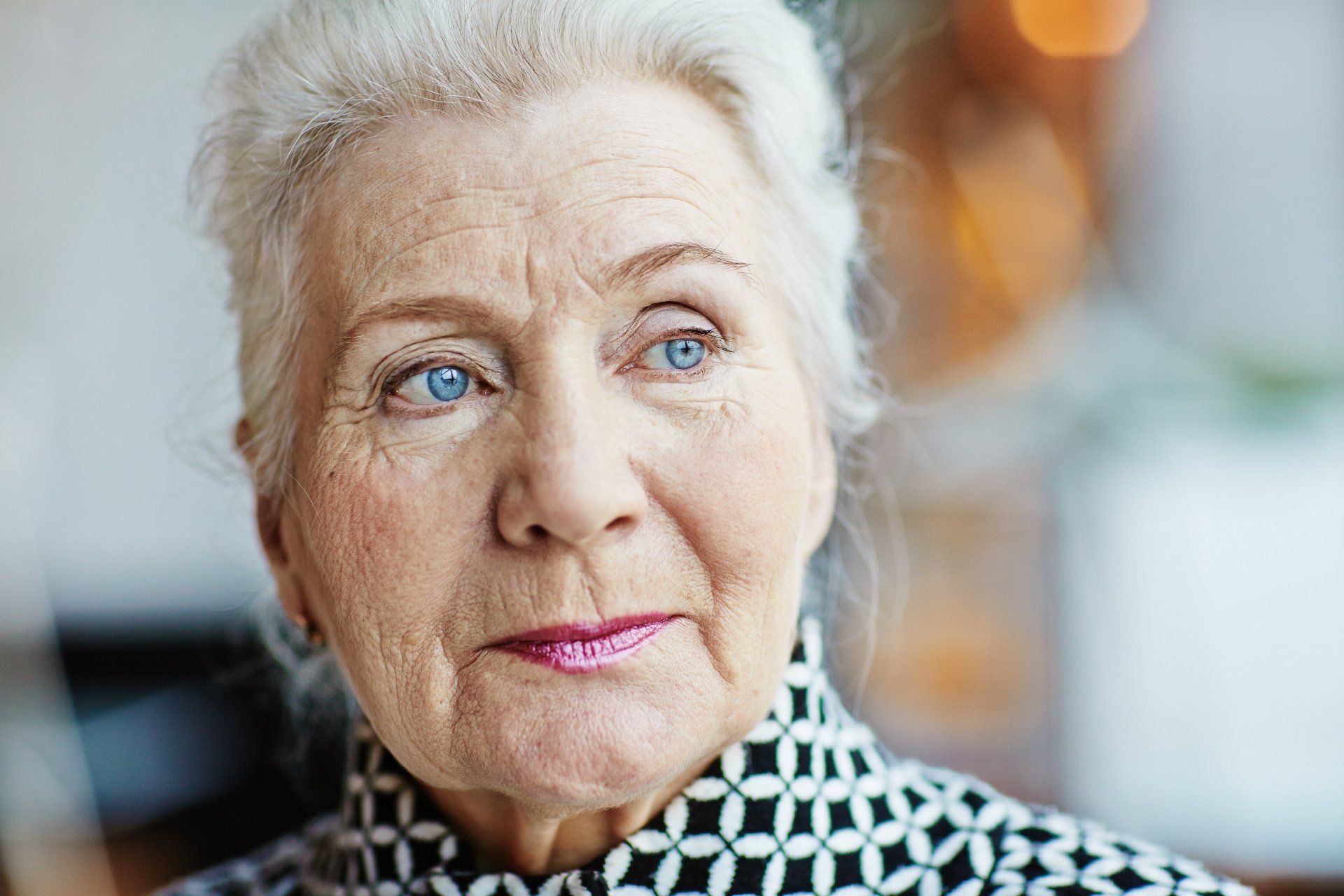 Close up of mature lady with blue eyes looking off to the right