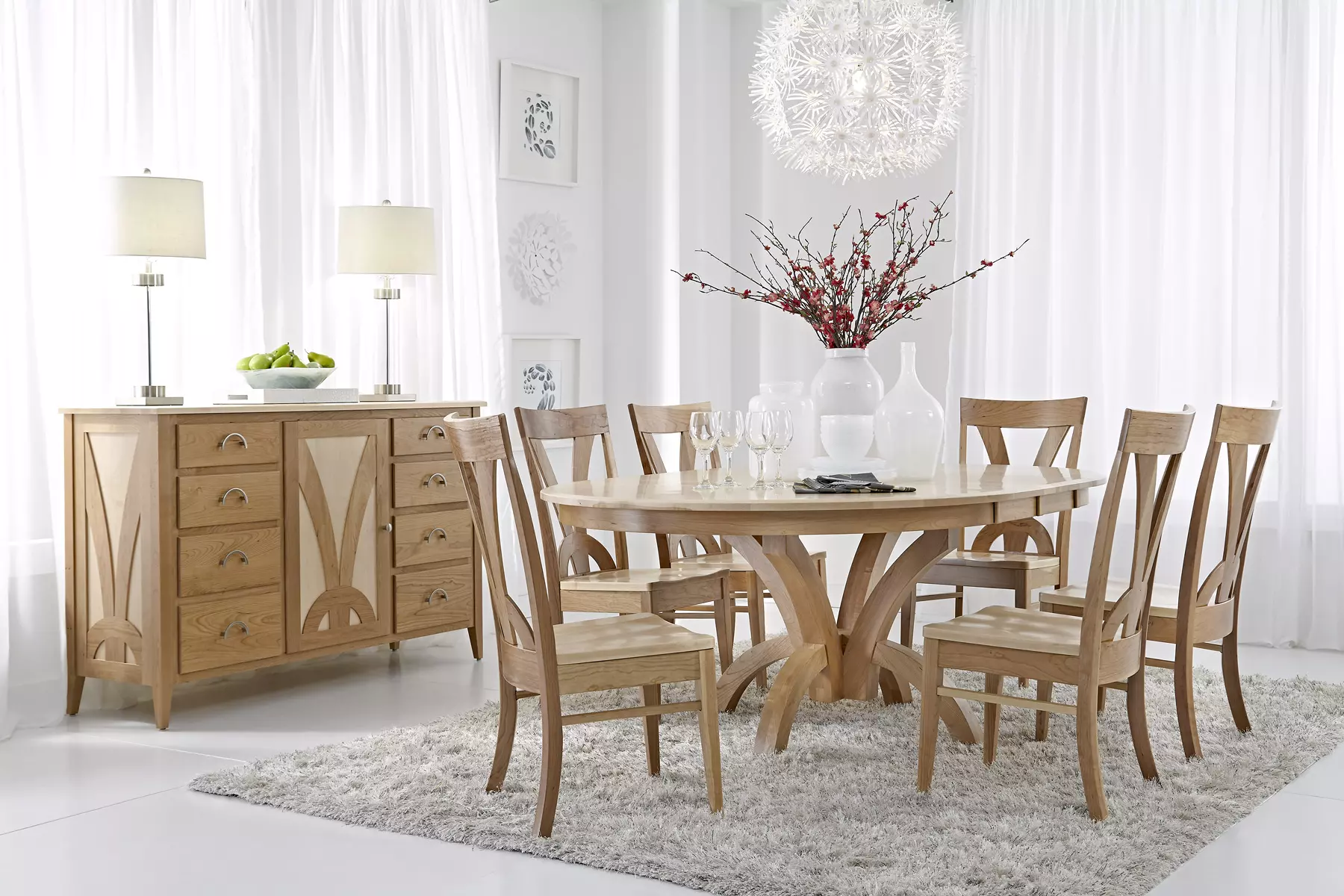 A dining room with a table and chairs and a dresser