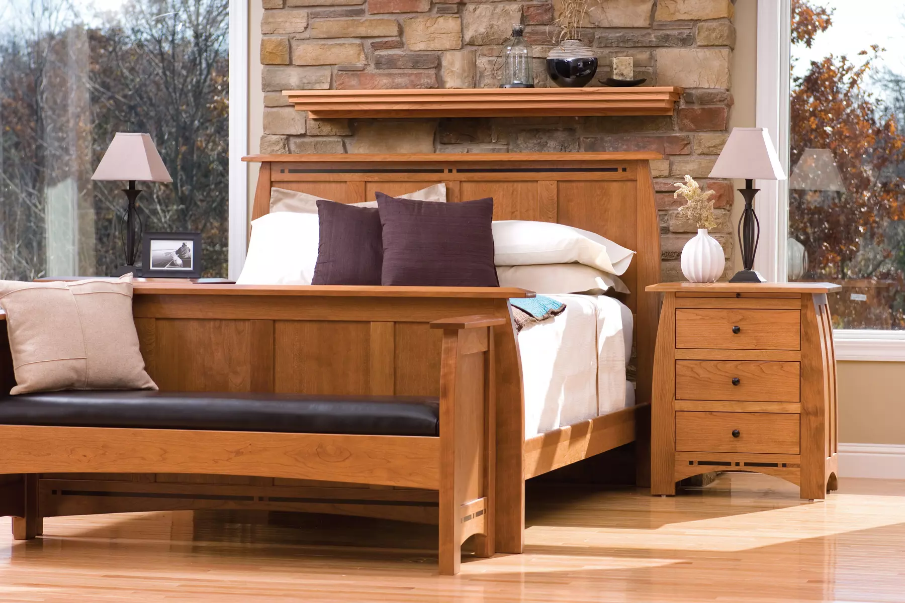 A bedroom with a wooden bed and a bench