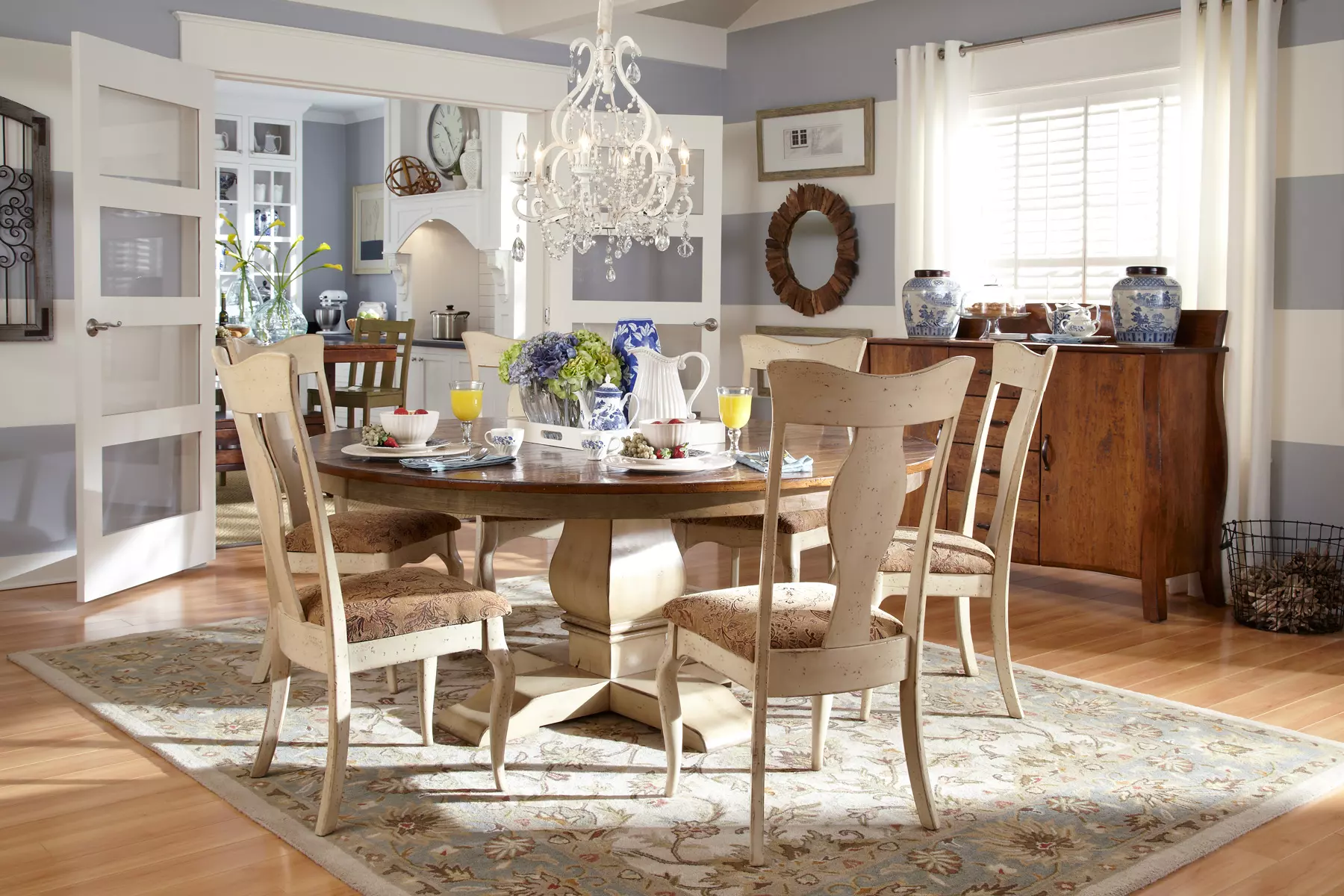 A dining room with a table and chairs and a chandelier