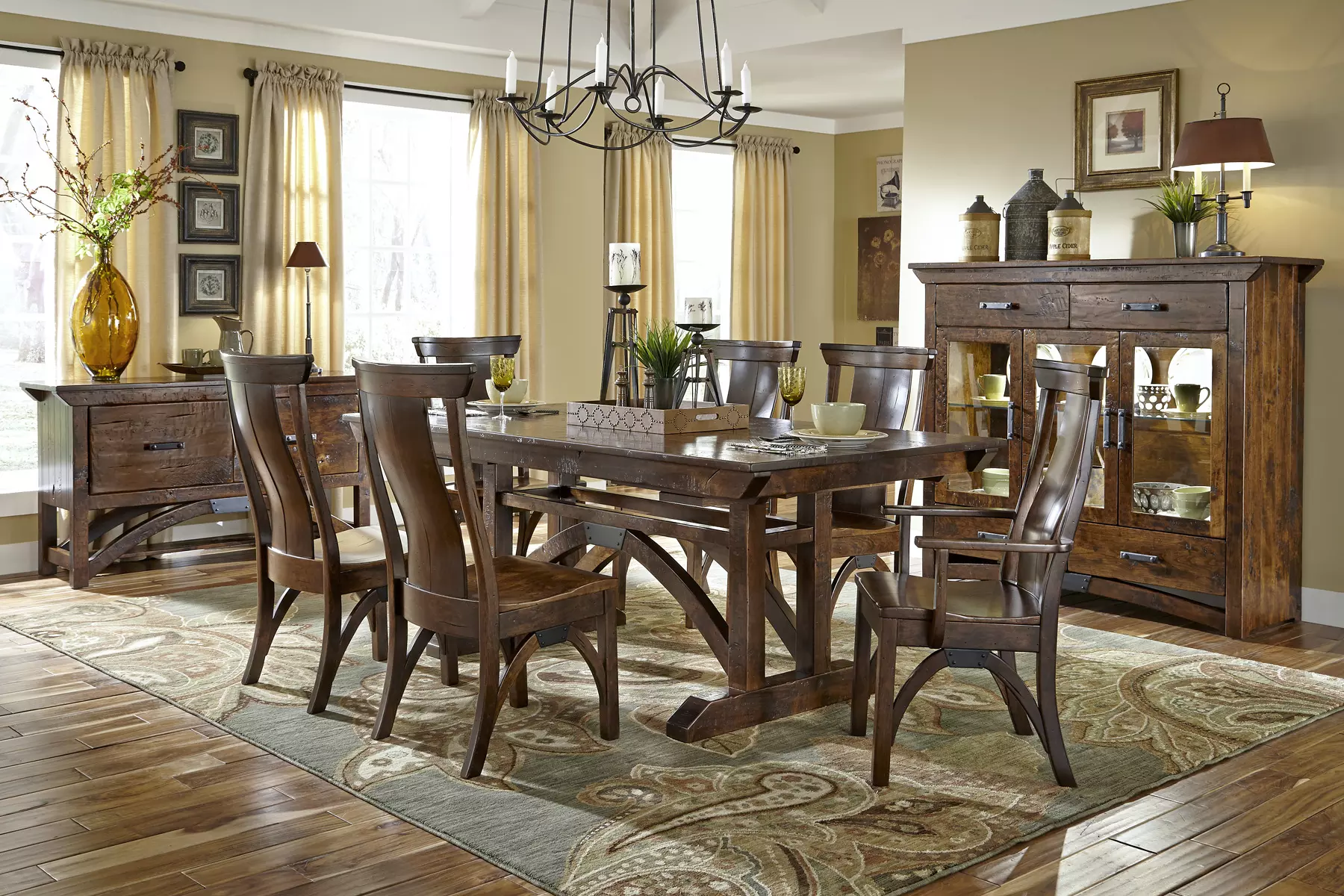 A dining room with a wooden table and chairs