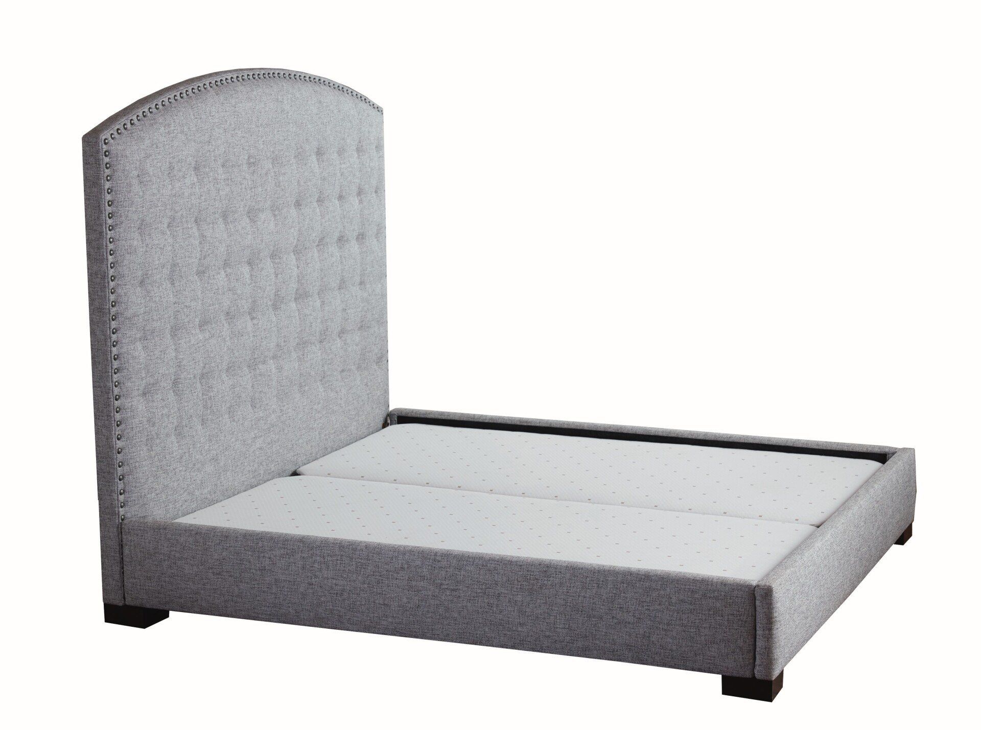 A bed with a grey headboard and a white mattress