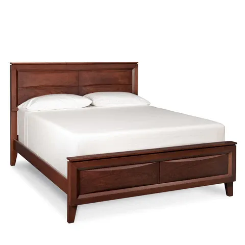 A wooden bed with white sheets and pillows on a white background.