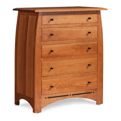 A wooden chest of drawers with black handles on a white background